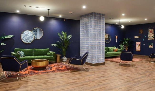 a room with a couch and chairs